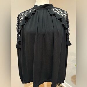 Free People women’s black long sleeve top with lace at shoulders, size large.